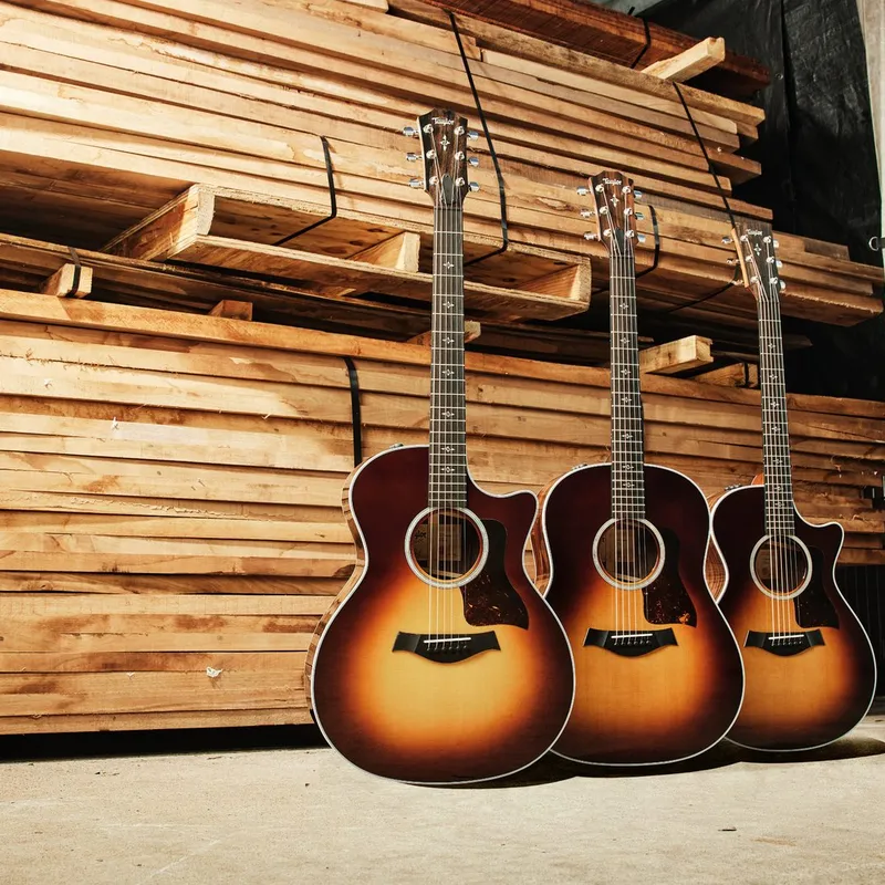 Three Taylor acoustic guitars in the wood shop