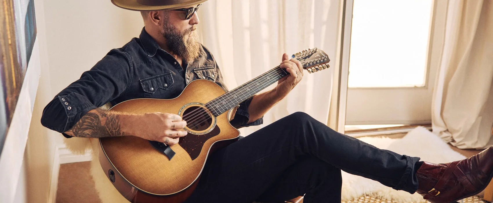 Image of a man playing a Taylor 12-string acoustic guitar