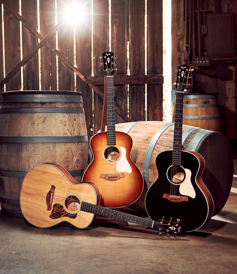 Three Taylor Gold Label Guitars in a rustic setting